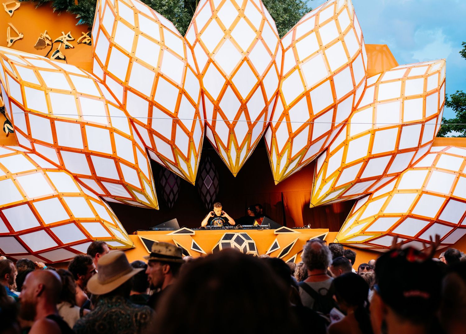 Elaborate wooden stage structure with intense lighting,overlooking a crowd at a large music festival. psy Solstice Festival Ruigoord Vivitu