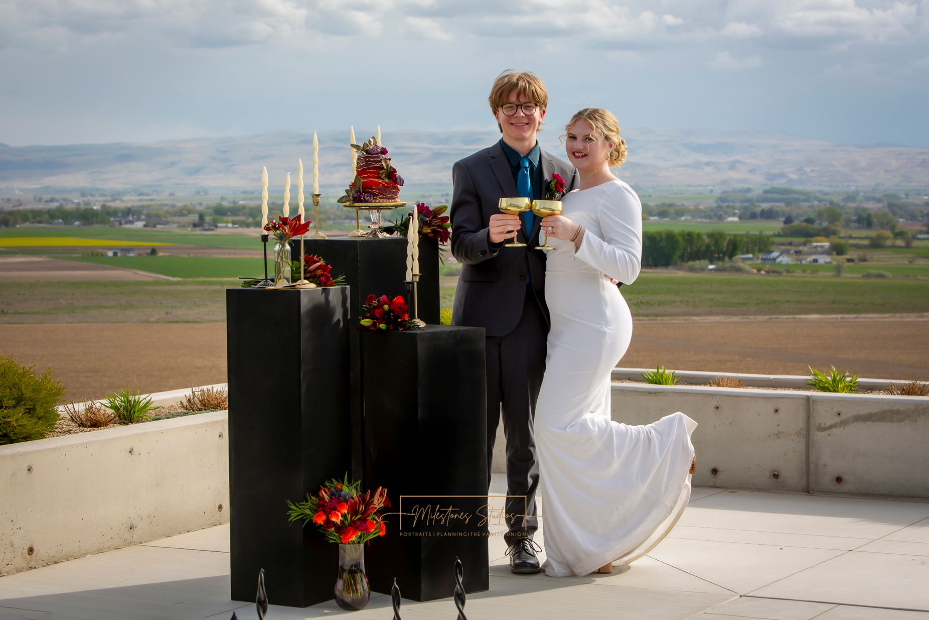 Garman Hill poolside jewel tone wedding bride and groom posing near black pillars with florals