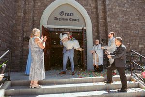 A sequence of photos showing two people practice-sparring with prop swords outside a brick building.