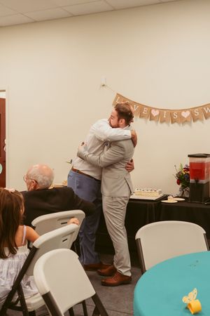 Four sequential photos show two people greeting each other with a warm embrace at what appears to be a party gathering.