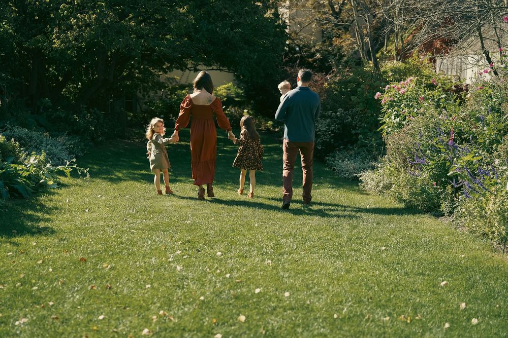 People gathered in a distant green field on a sunny day.