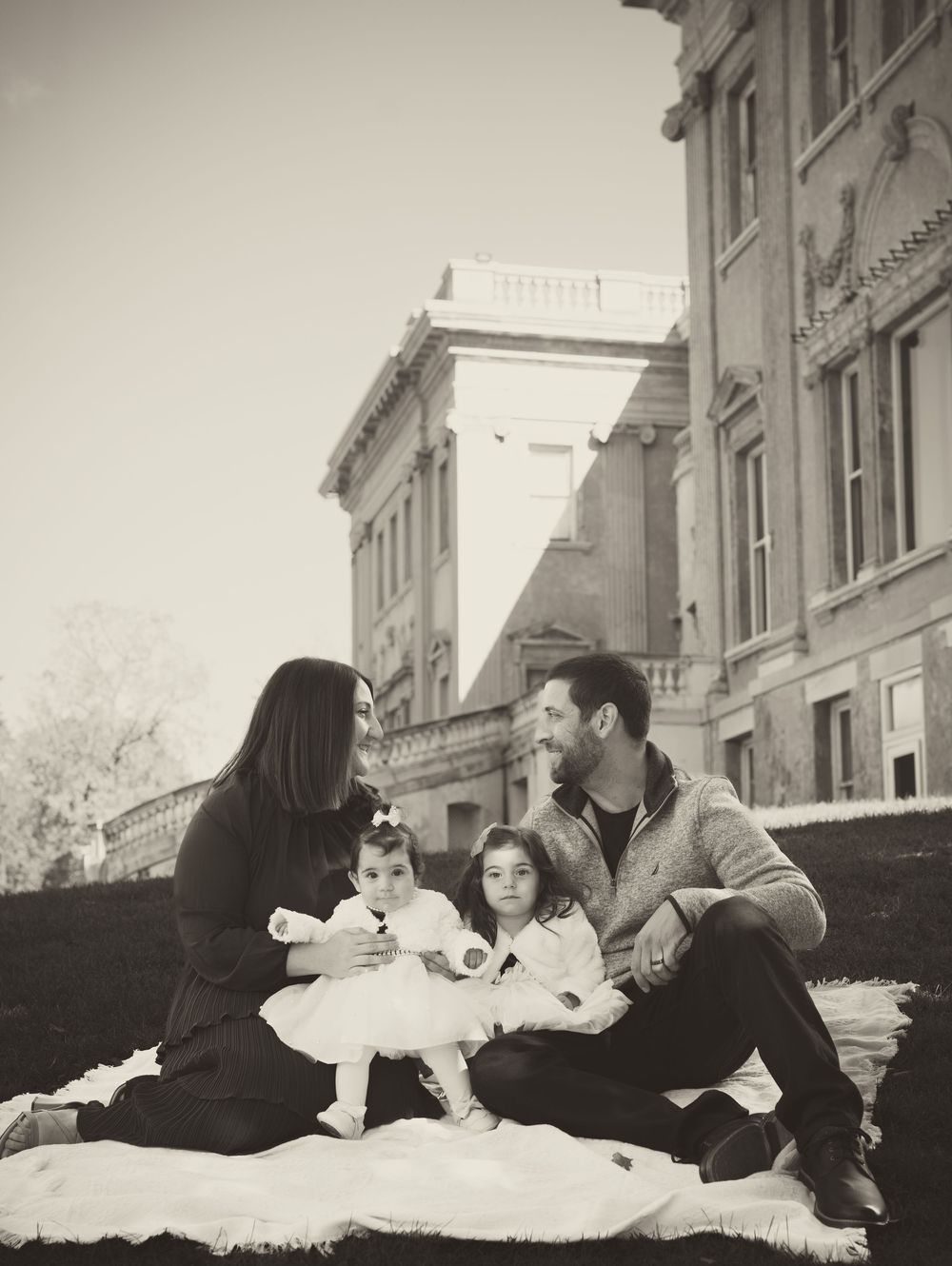 Black and white family portrait series showing intimate moments on a couch. Family Photoshoot. Family Photographer