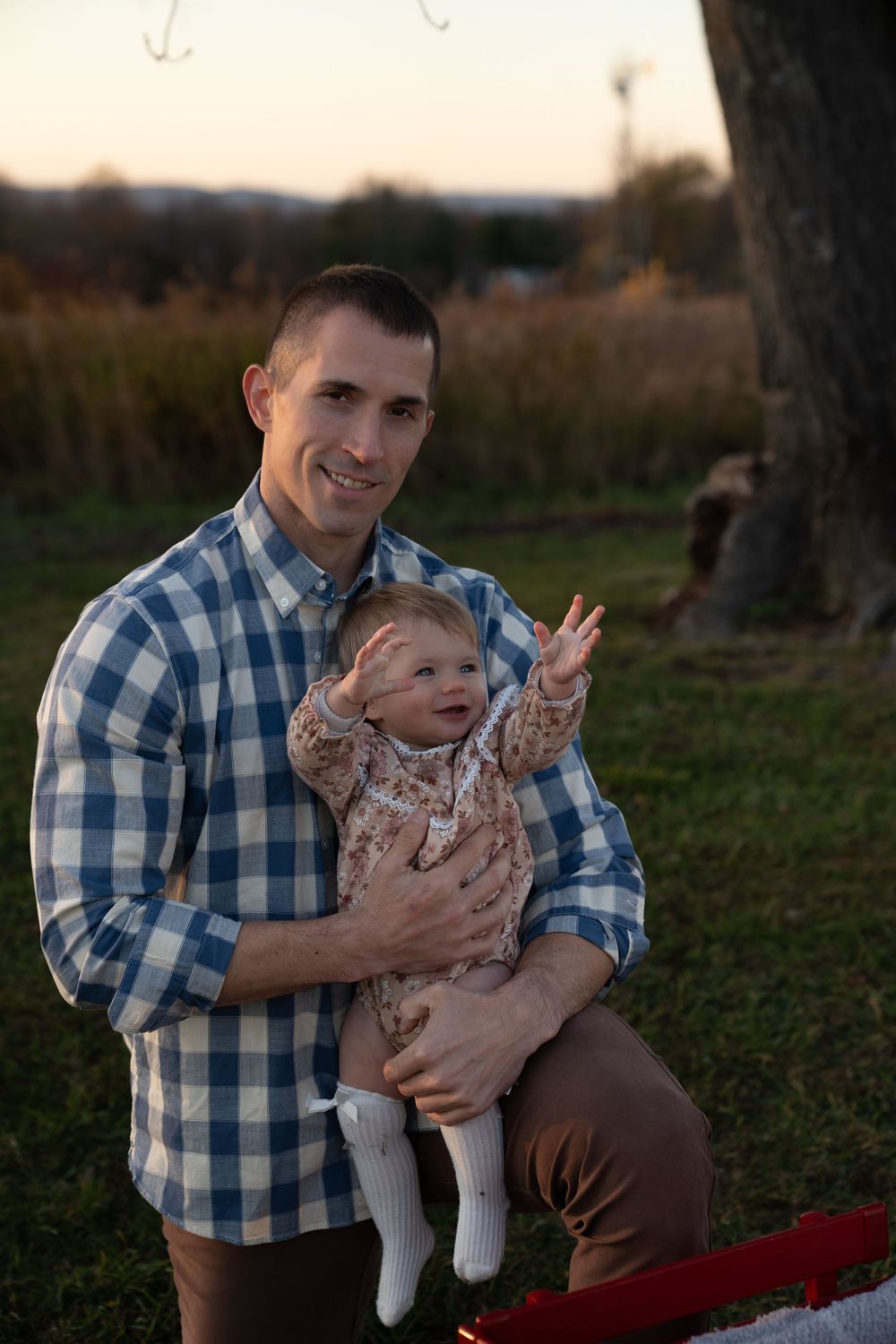 Playful outdoor family moments captured at sunset with joyful expressions and casual attire.