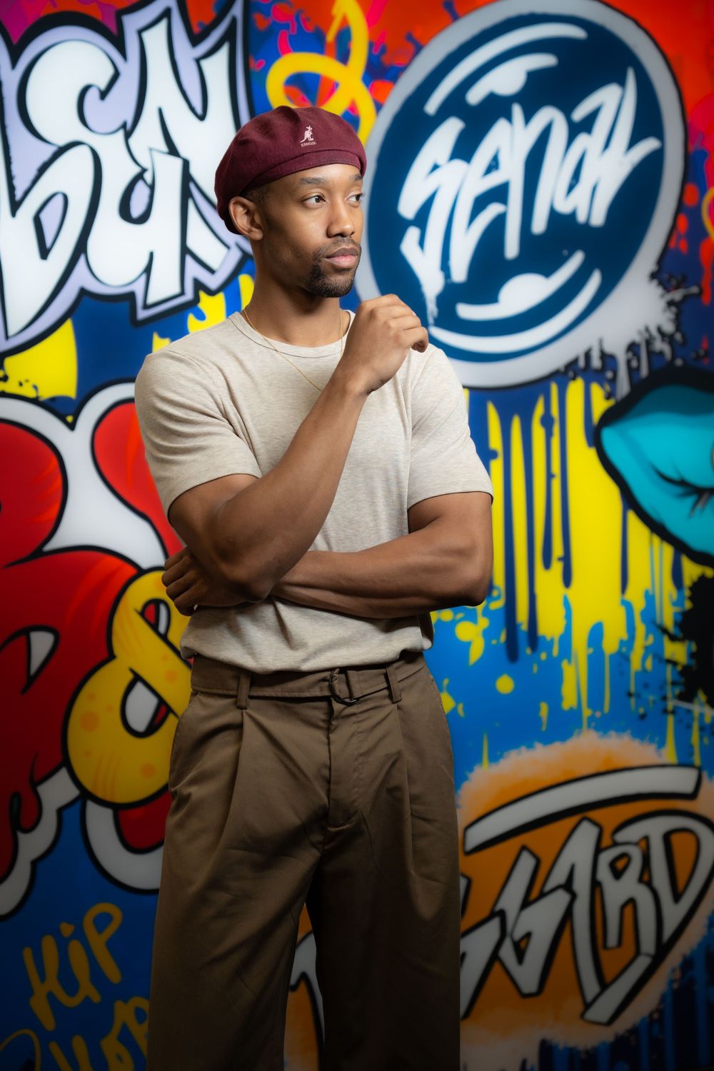 Urban fashion portrait with colorful graffiti backdrop featuring casual street style.