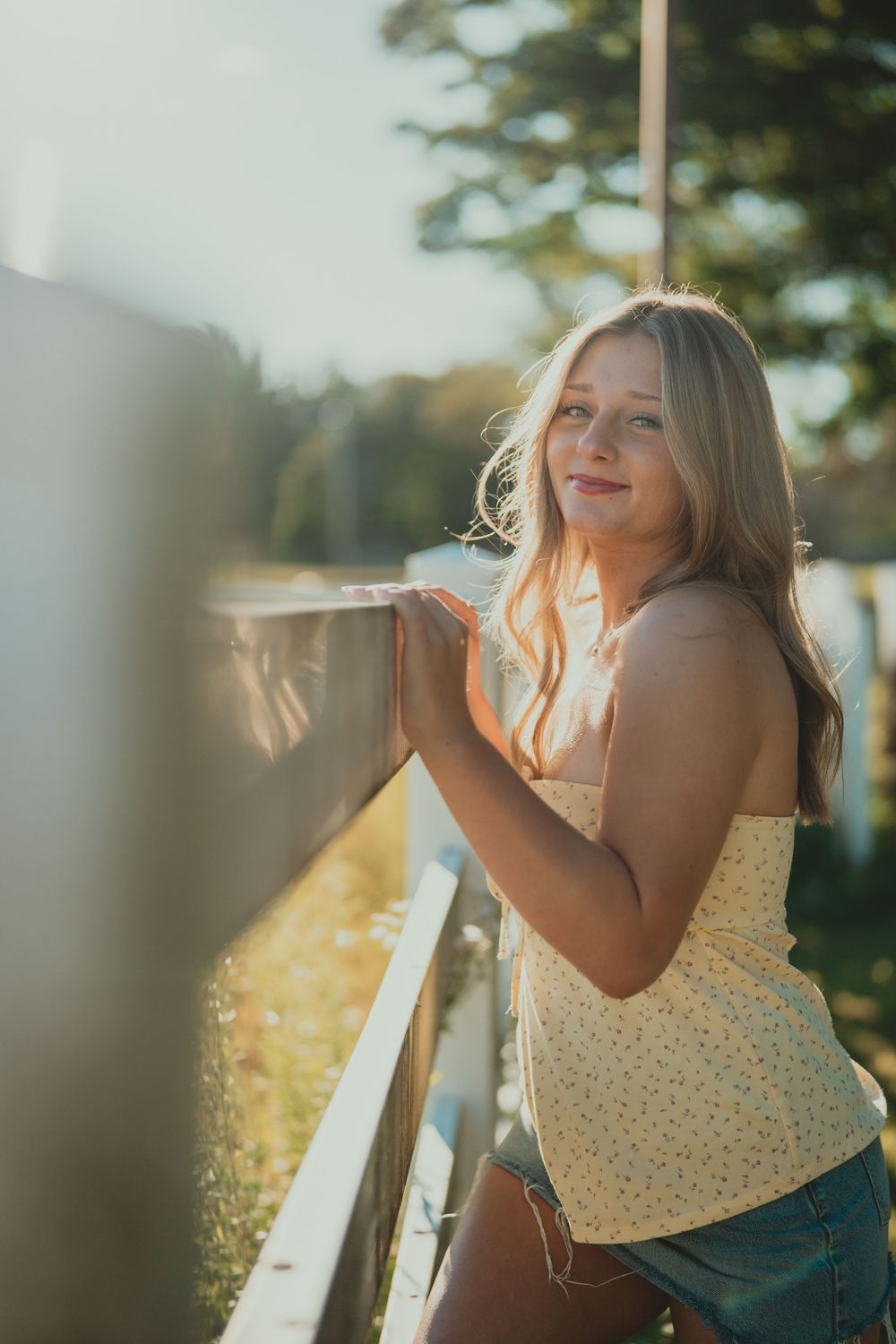 Artistic portrait series captured in warm evening light with natural outdoor backdrop.