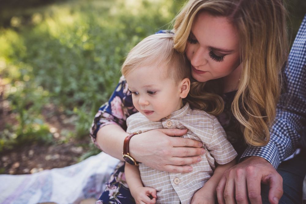 Series of six intimate outdoor family portraits showing loving embraces and tender moments in a natural setting.