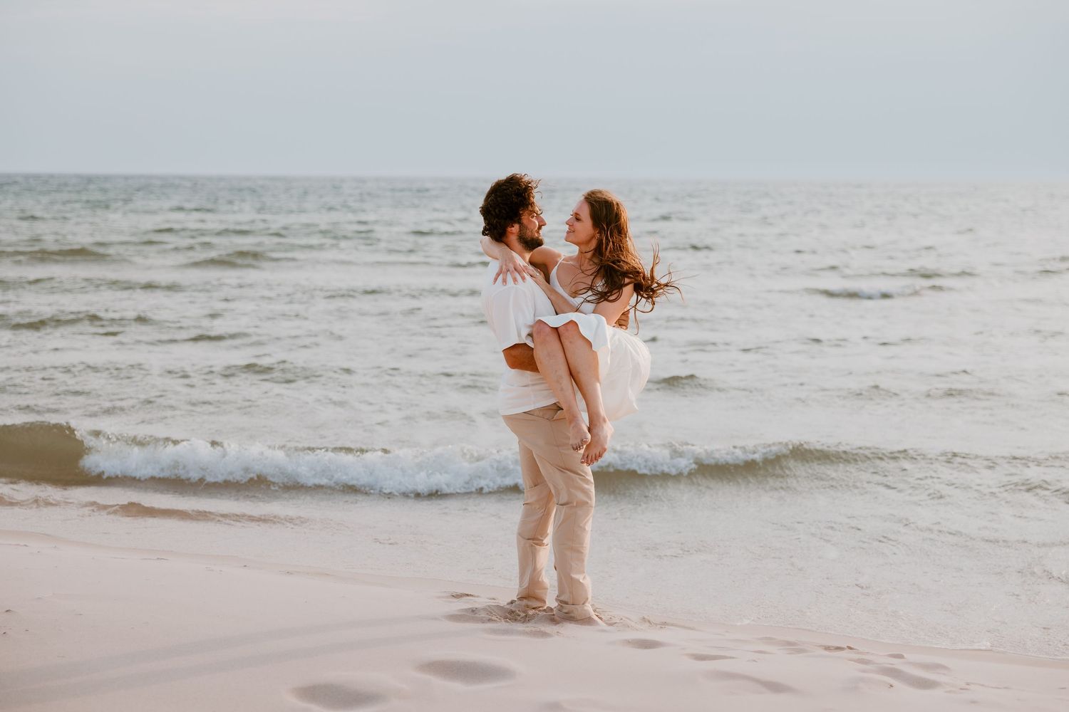 A series of romantic beach photos shows a couple enjoying a sunset together along the shoreline. Novi Couples Photography Engagement Wedding