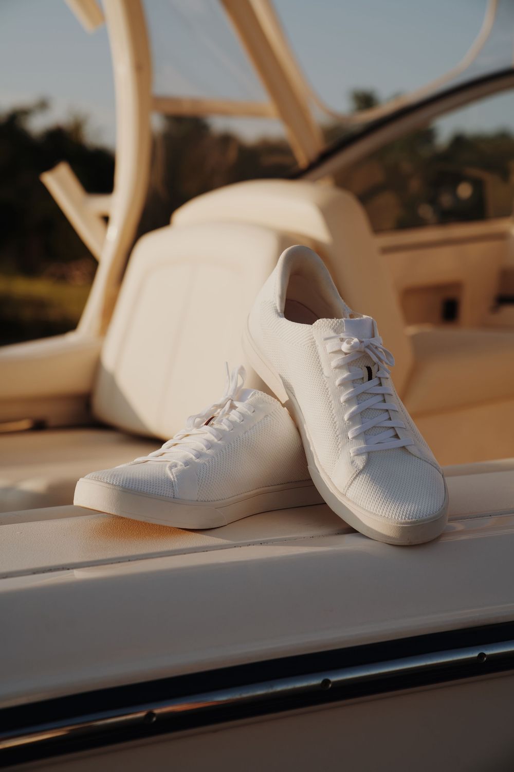 White canvas sneakers displayed in a row on a white surface.