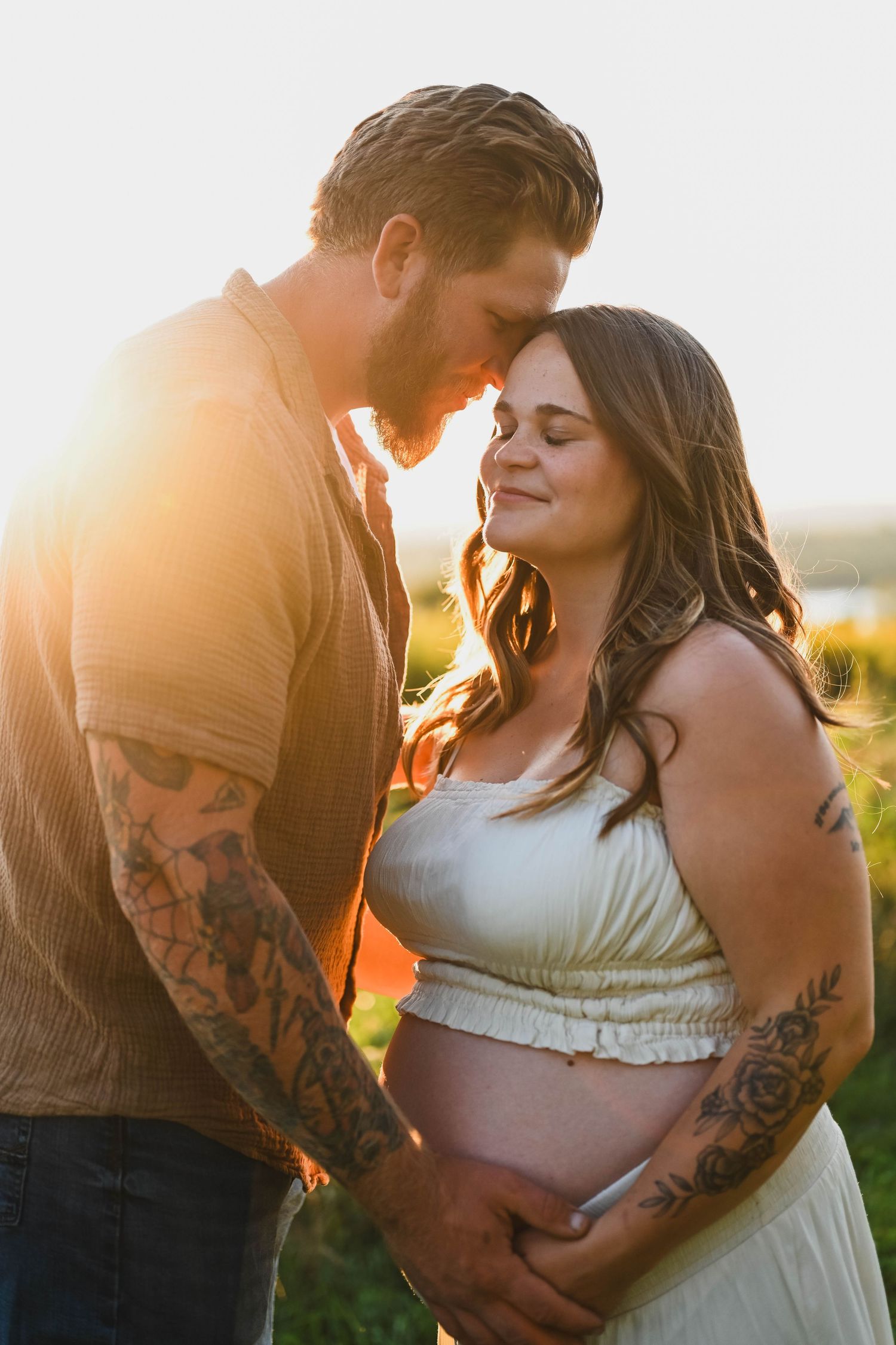 Tattooed Mama and Dad to be in a golden hour session with Krista Manchuck in Hudson, NY
