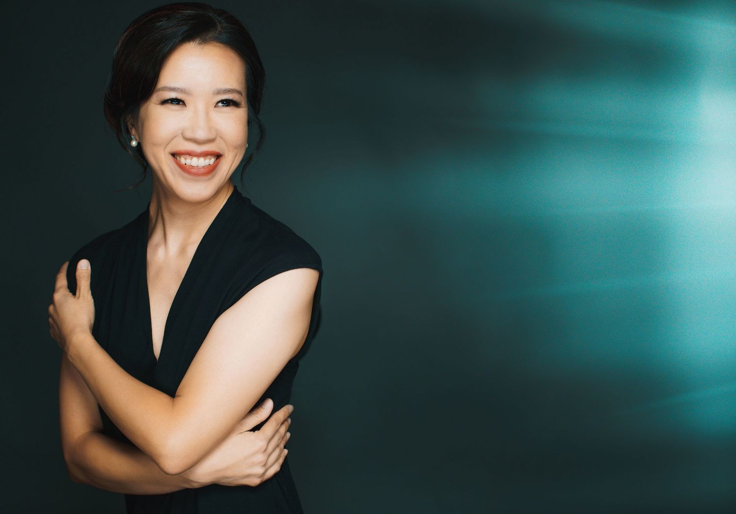 A series of five professional portrait photos in black attire against a dark teal and black background.