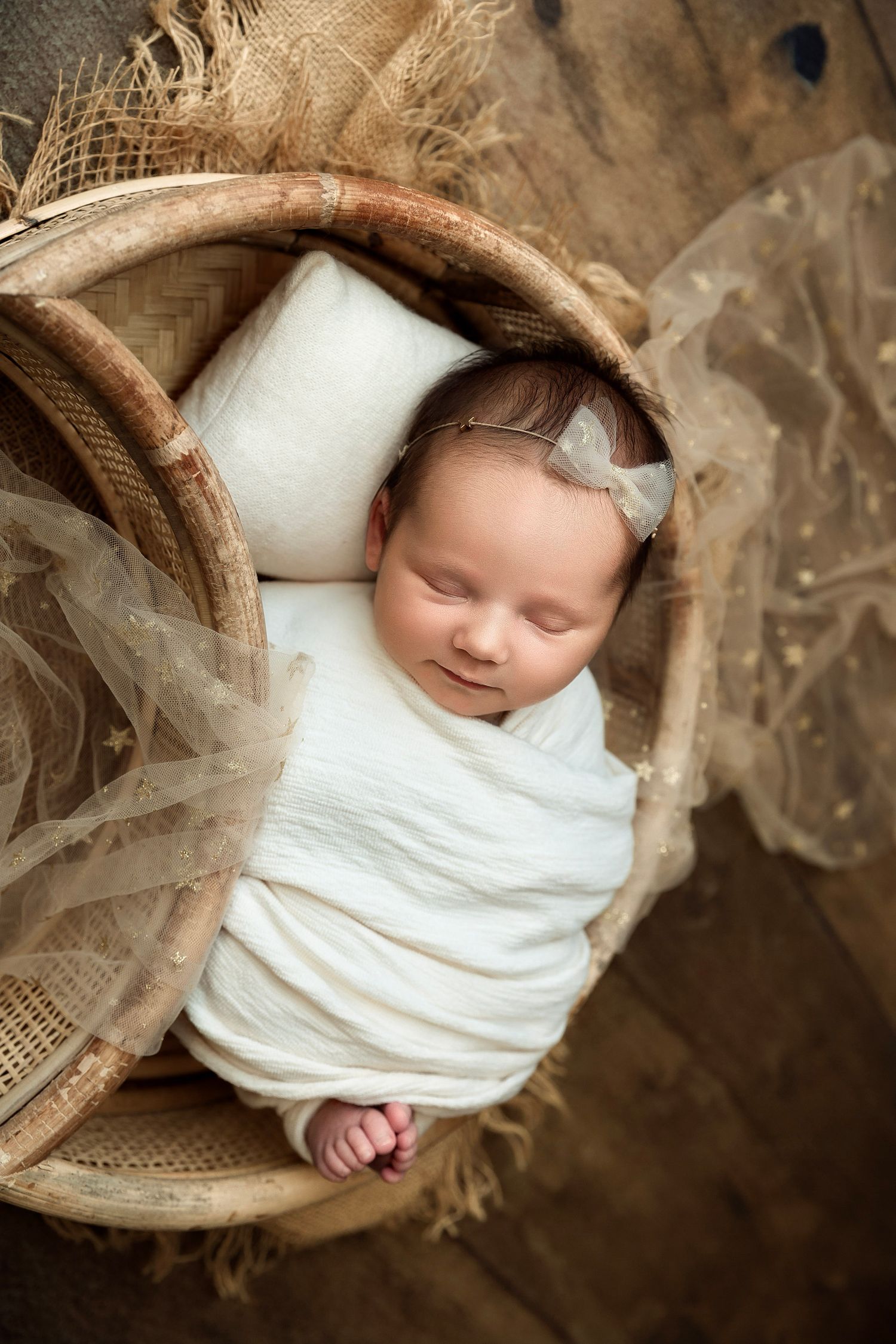 Newborn sleeping in basket during fine art photography session