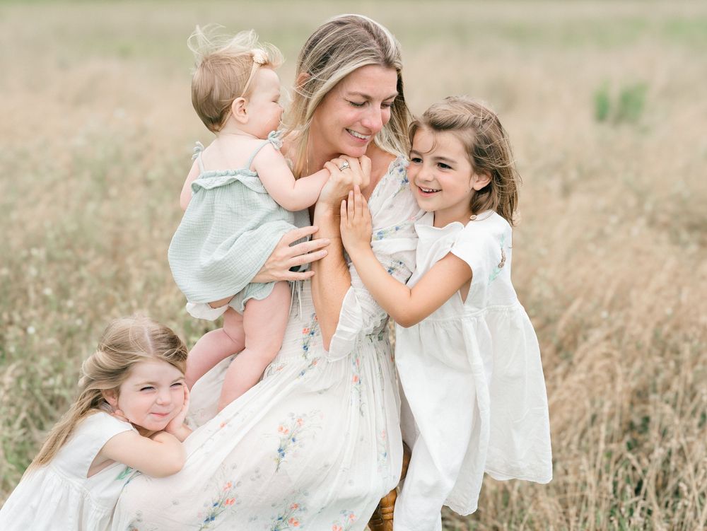 A mother holds her baby while Lauren Marie photography photographs them.