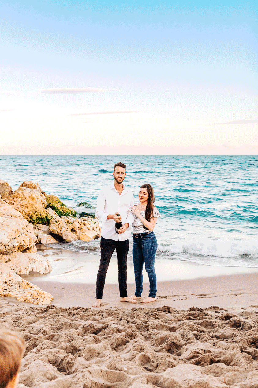 Engagement session on the beach with champagne pop celebration in Palm Beach County by Photogenic Fox Photography
