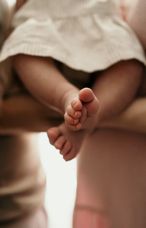 Close-up detail of tiny baby feet in soft natural lighting.
