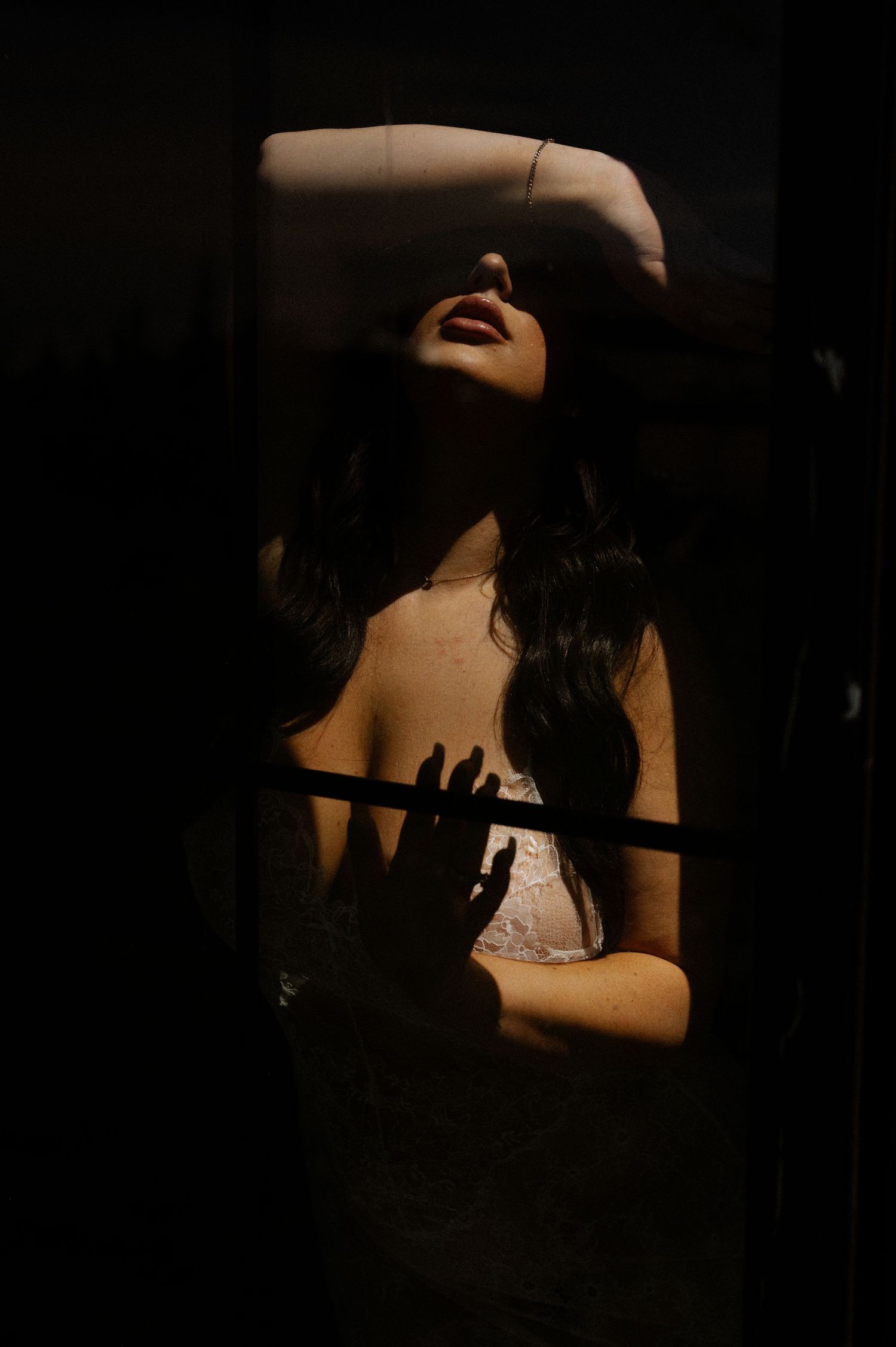 Artistic portrait series showing silhouette of figure with long hair tilting head back against dark background.