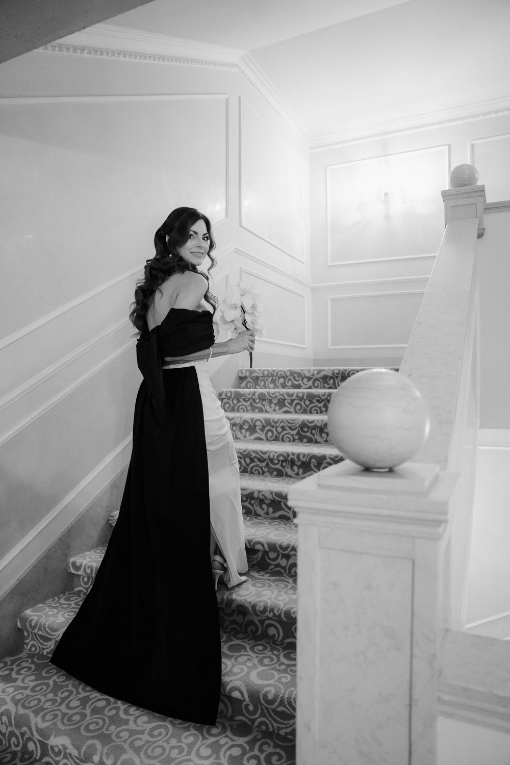 Dramatic black and white photos on elegant carpeted stairs with white walls. Photoshoot by Venice Photographer Alina Indi