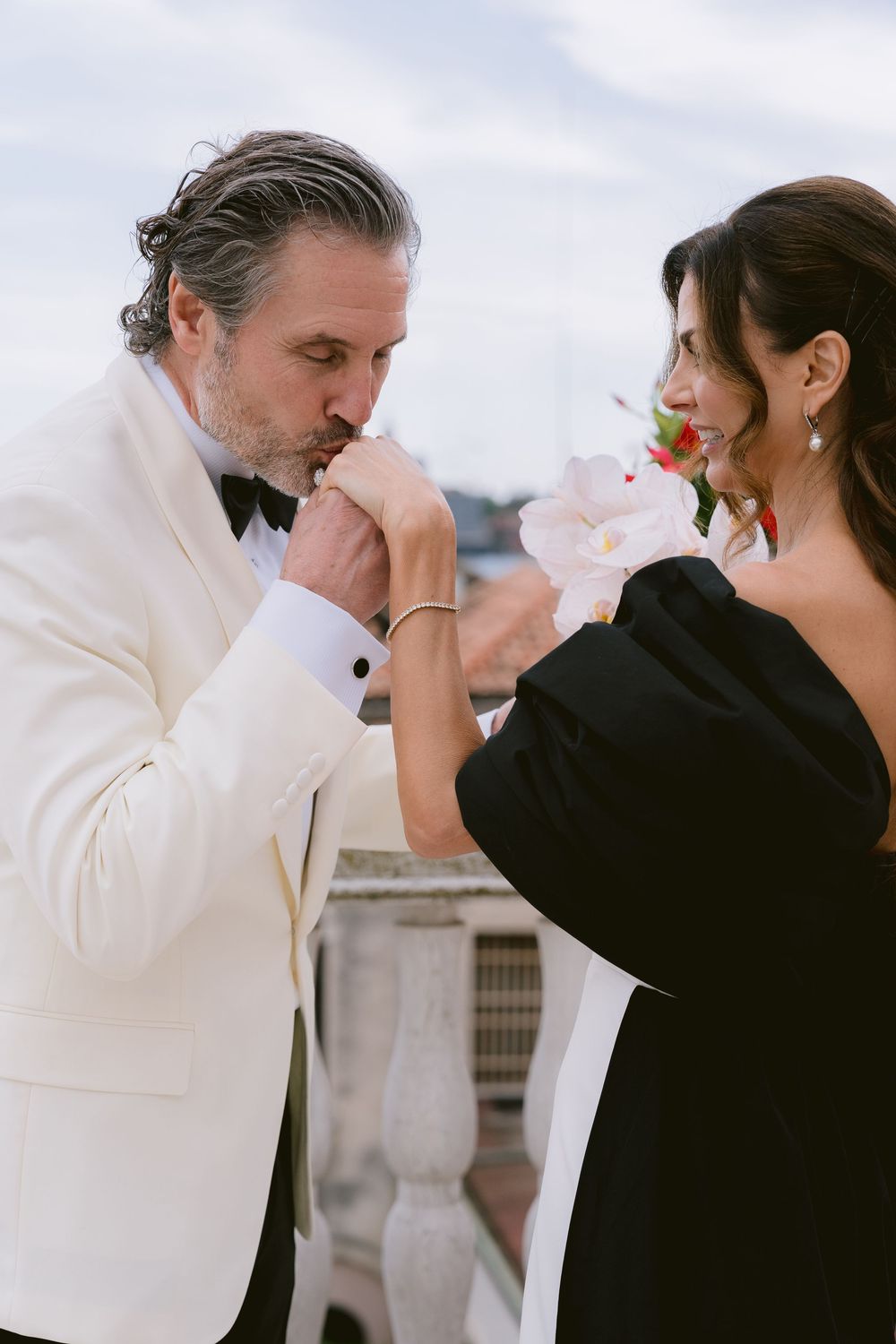 Romantic sequence of couple in black and white formal wear sharing tender moments. Photoshoot by Venice Photographer Alina Indi