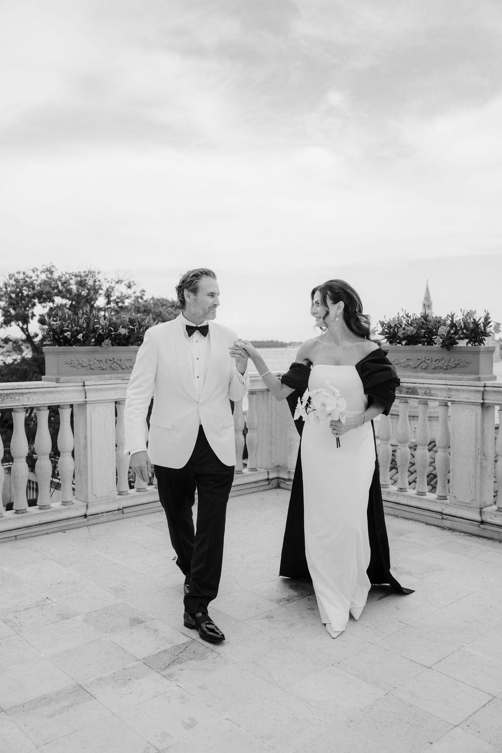 Artistic wedding photography sequence showing couple's interaction on marble balcony. Photoshoot by Venice Photographer Alina Indi