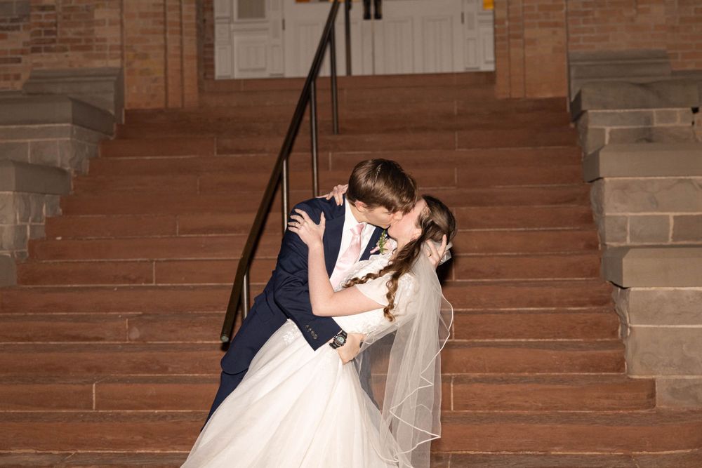 Dip and kiss during reception exit.