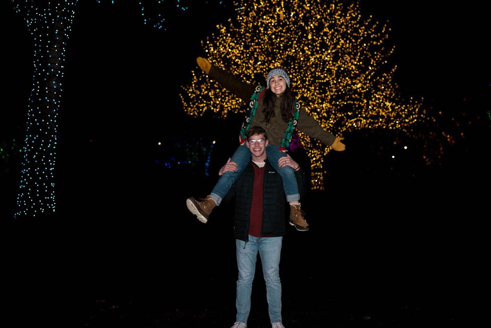 Couple portrait looking at Christmas Lights