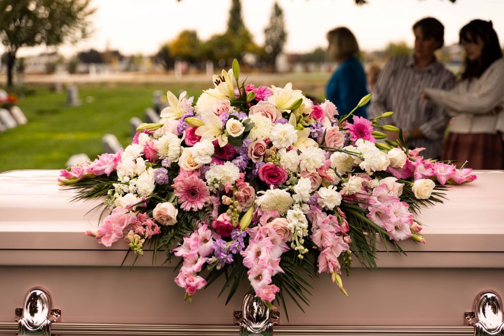 Detail shot of flowers and casket at a funeral