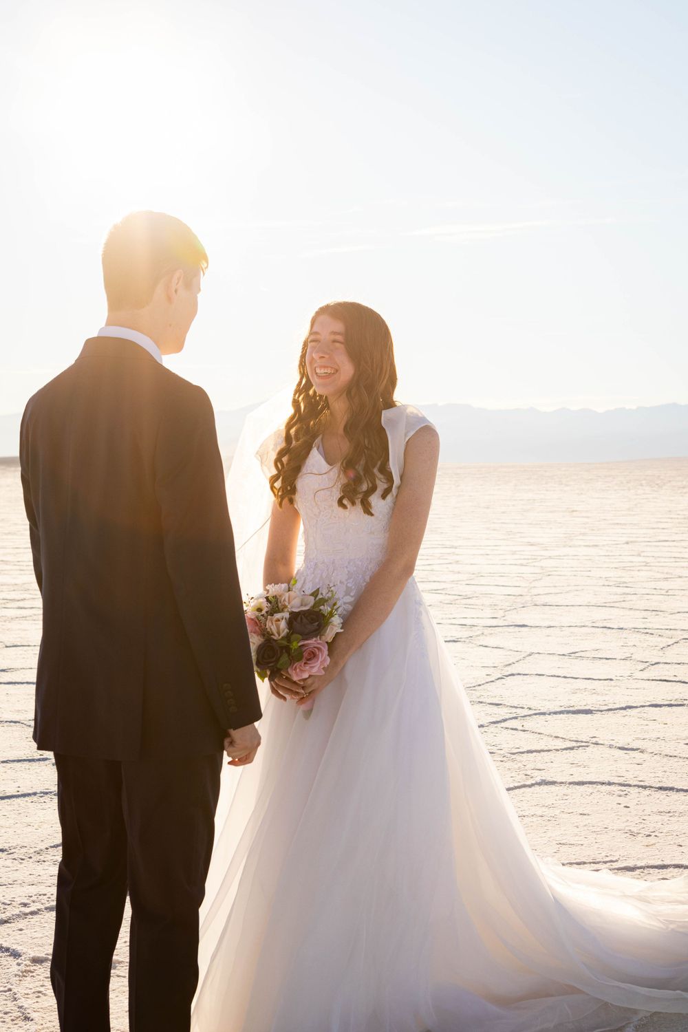 Bride and groom smiling at each other during bridal photo shoot