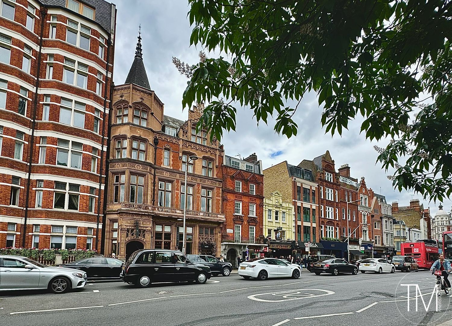 Row of historic Victorian red brick buildings with ornate architecture in London.