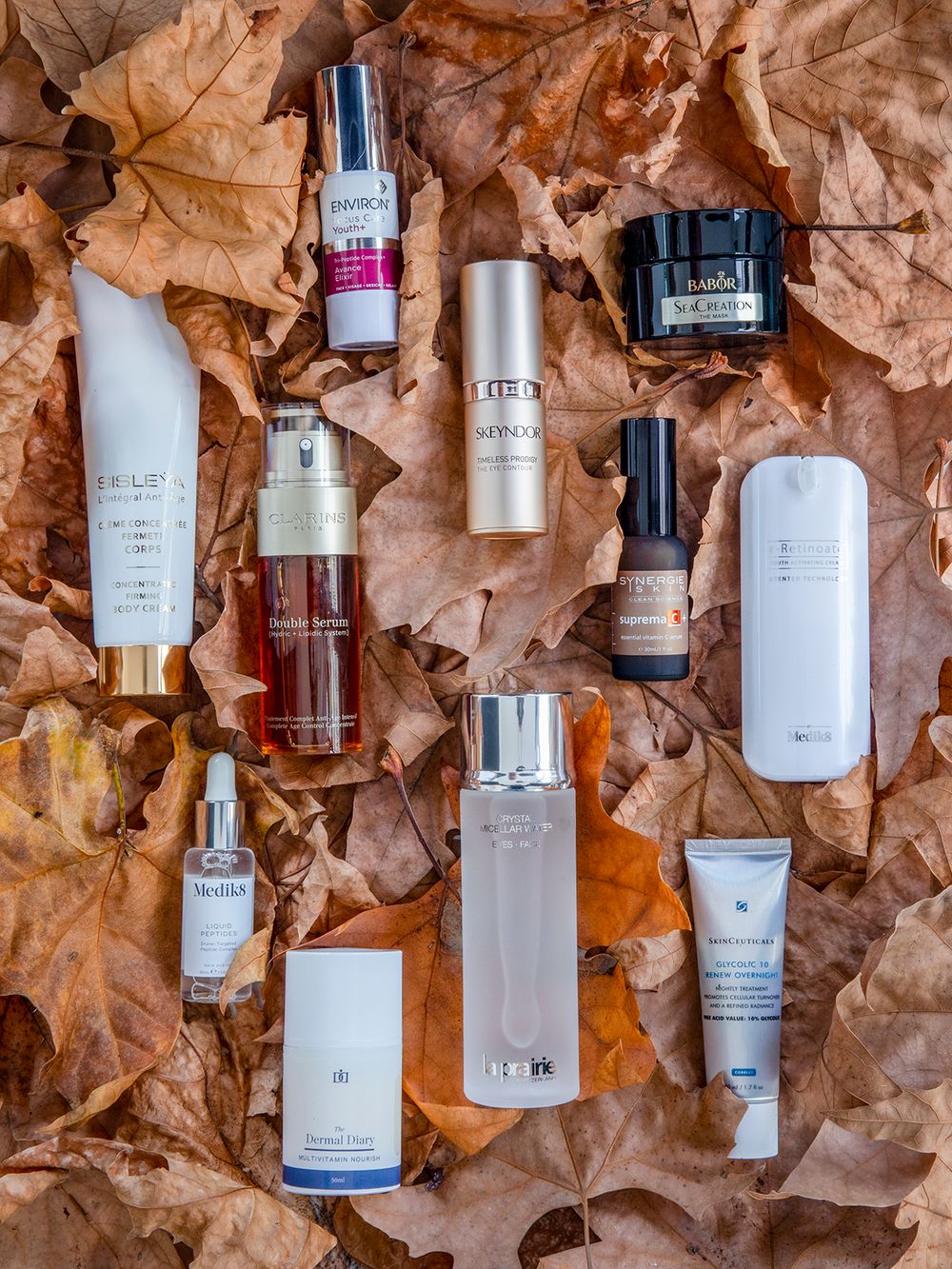 womens anti-aging products sitting amongst autumn leaves