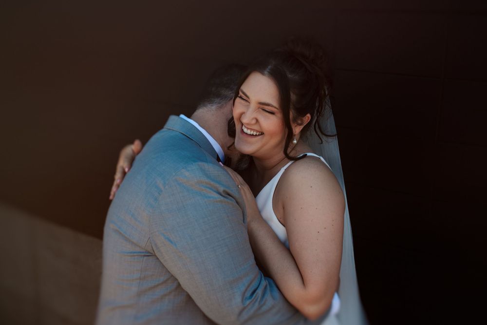 A romantic couple embraces during an intimate dance at a dimly lit event in Indianapolis Indiana.
