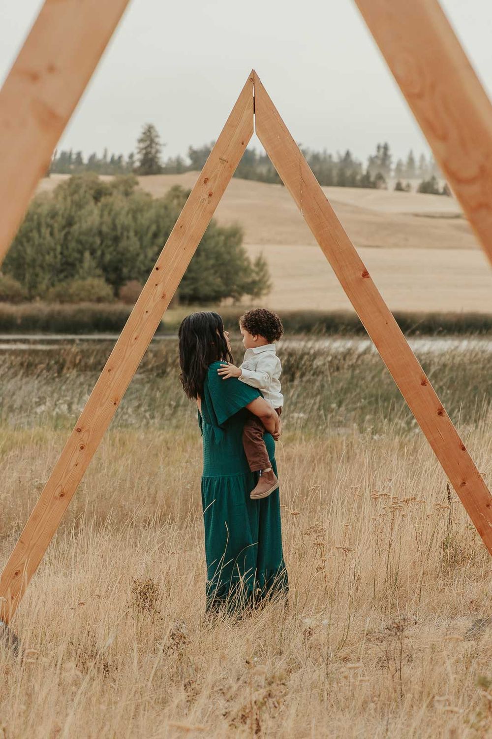 Golden hour maternity photo with Spokane maternity photographer Elishia Jackson, featuring a peaceful outdoor backdrop