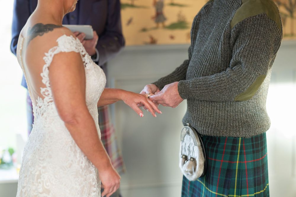 Wedding couple sharing an intimate dance with the groom wearing a traditional Scottish kilt.