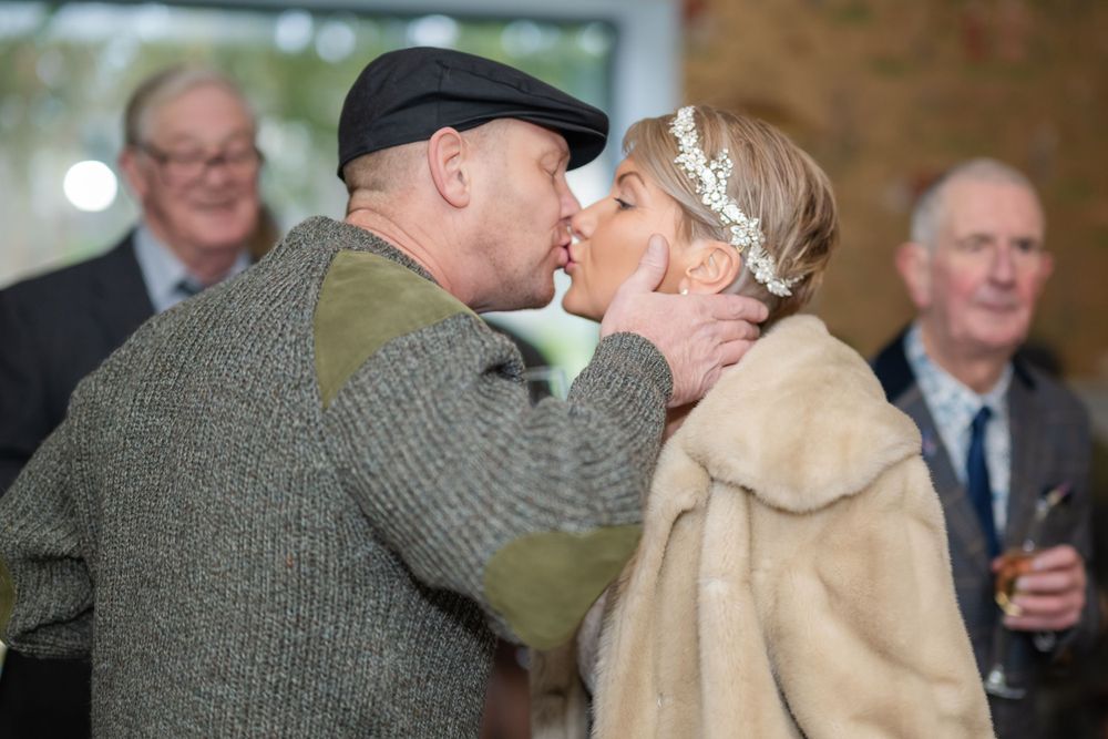 Wedding couple sharing a romantic moment during their Scottish-themed celebration.