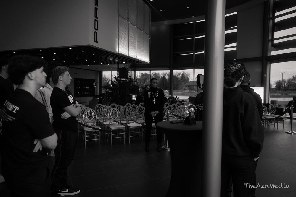 Event attendees gather in a modern venue space with decorative lighting.