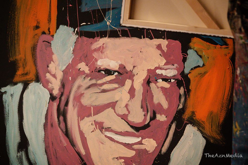 Colorful artistic portrait painting with bright orange background.