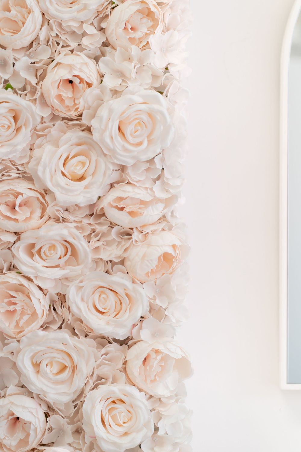 Close-up of soft blush pink roses creating a romantic floral wall display.