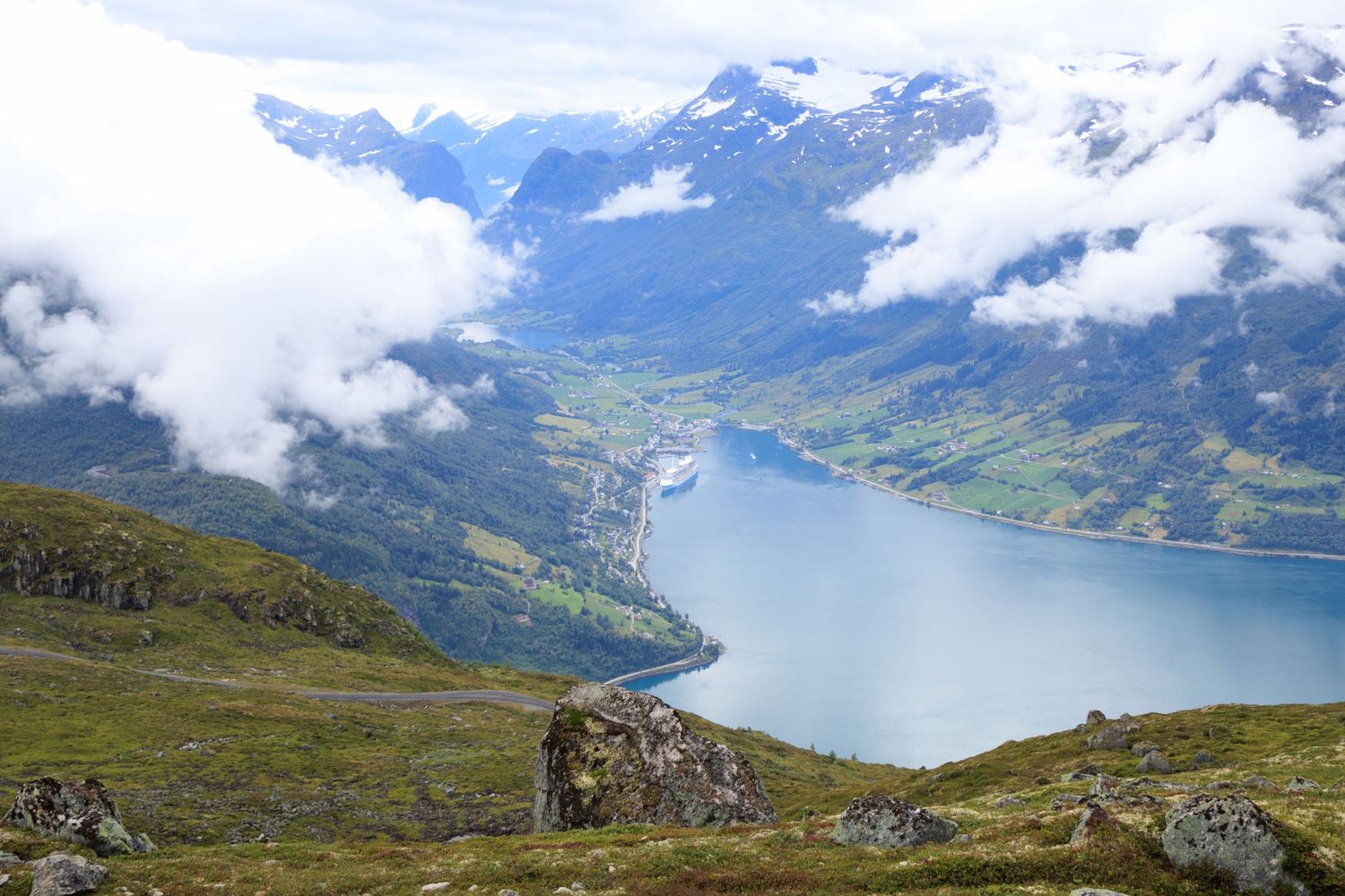 Panoramic view of Norwegian fjord and valley from mountain hiking trail.