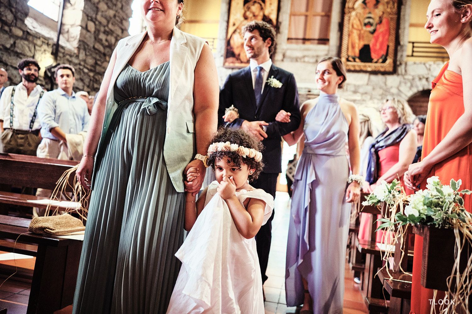 TLOOK photographe de mariage de style documentaire, à la cérémonie religieuse les invités entrent dans l'église