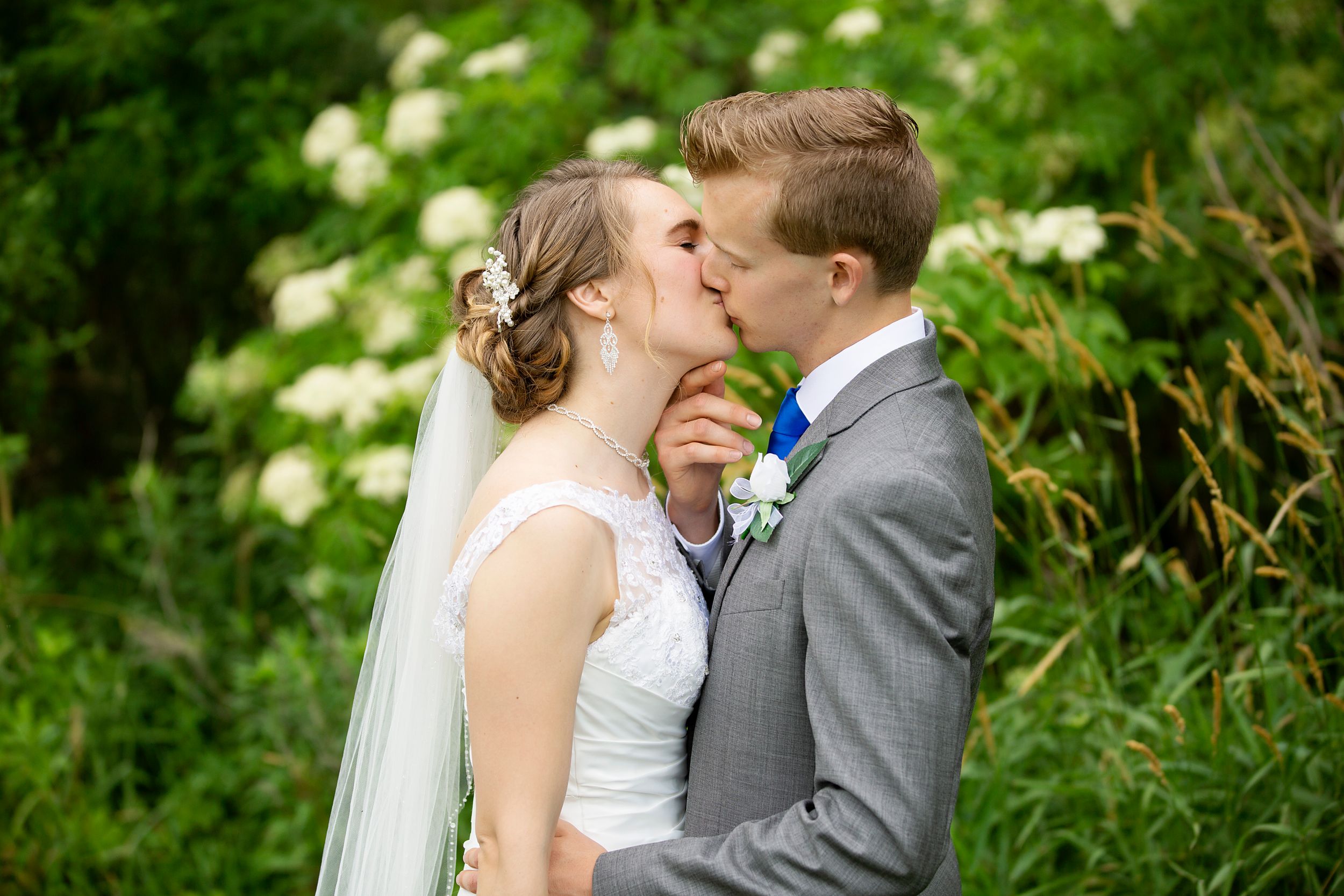An intimate wedding moment shared in a blooming garden setting.