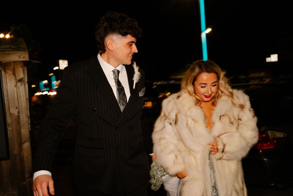 Bride and groom walking at night in Weymouth during their New Year’s Eve wedding