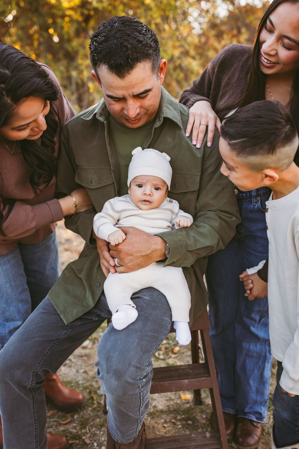 A candid series of photos showing a family playing and laughing together outdoors during an autumn photoshoot.