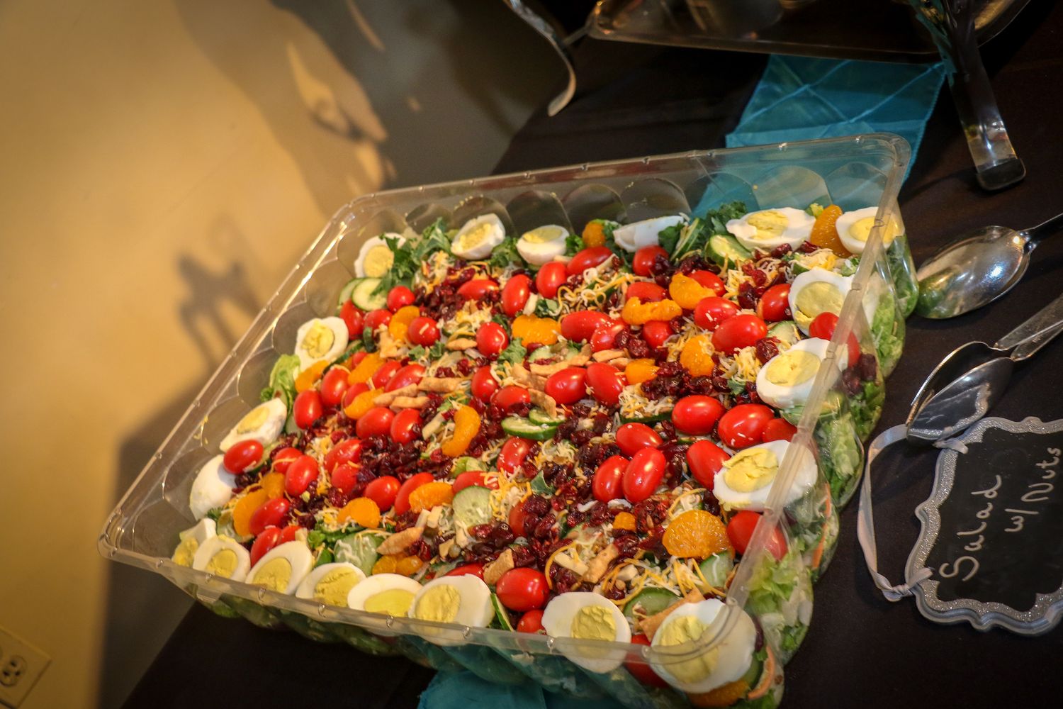 Fresh colorful vegetables and mozzarella arranged on a wooden serving board for a charcuterie platter.