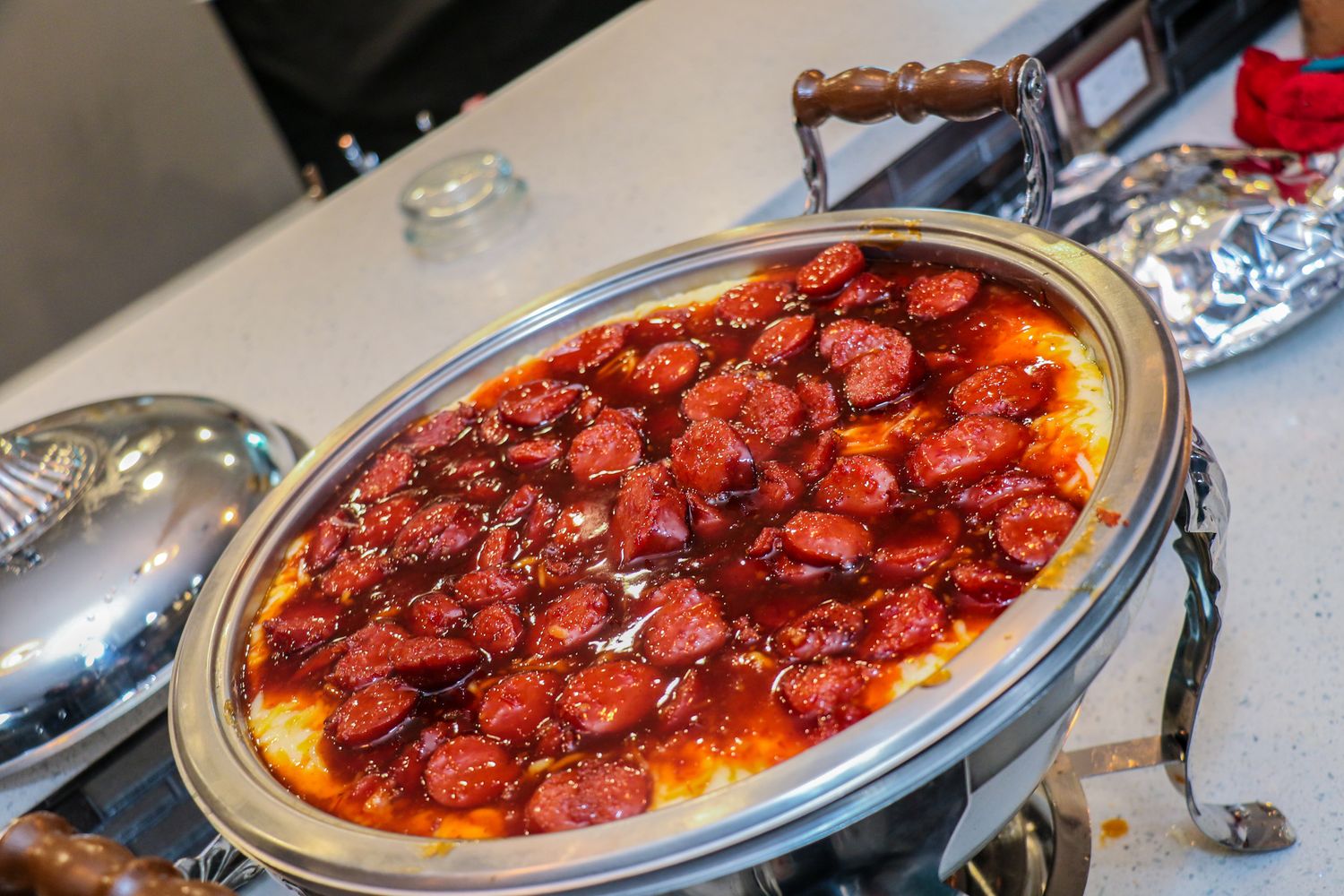 Pepperoni pizza with melted cheese and tomato sauce served on a silver platter.