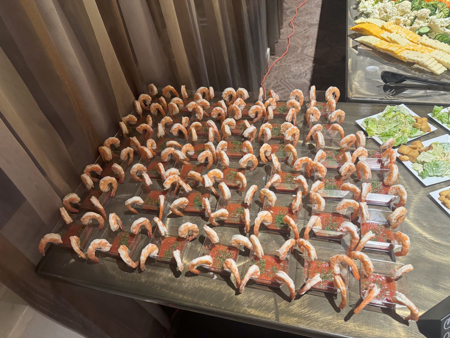Rows of chocolate-dipped candy canes arranged neatly on a baking sheet.
