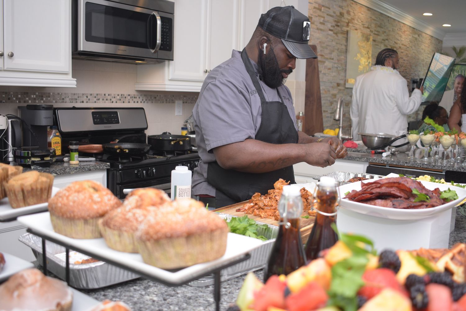 Professional catering setup with various food stations and servers.