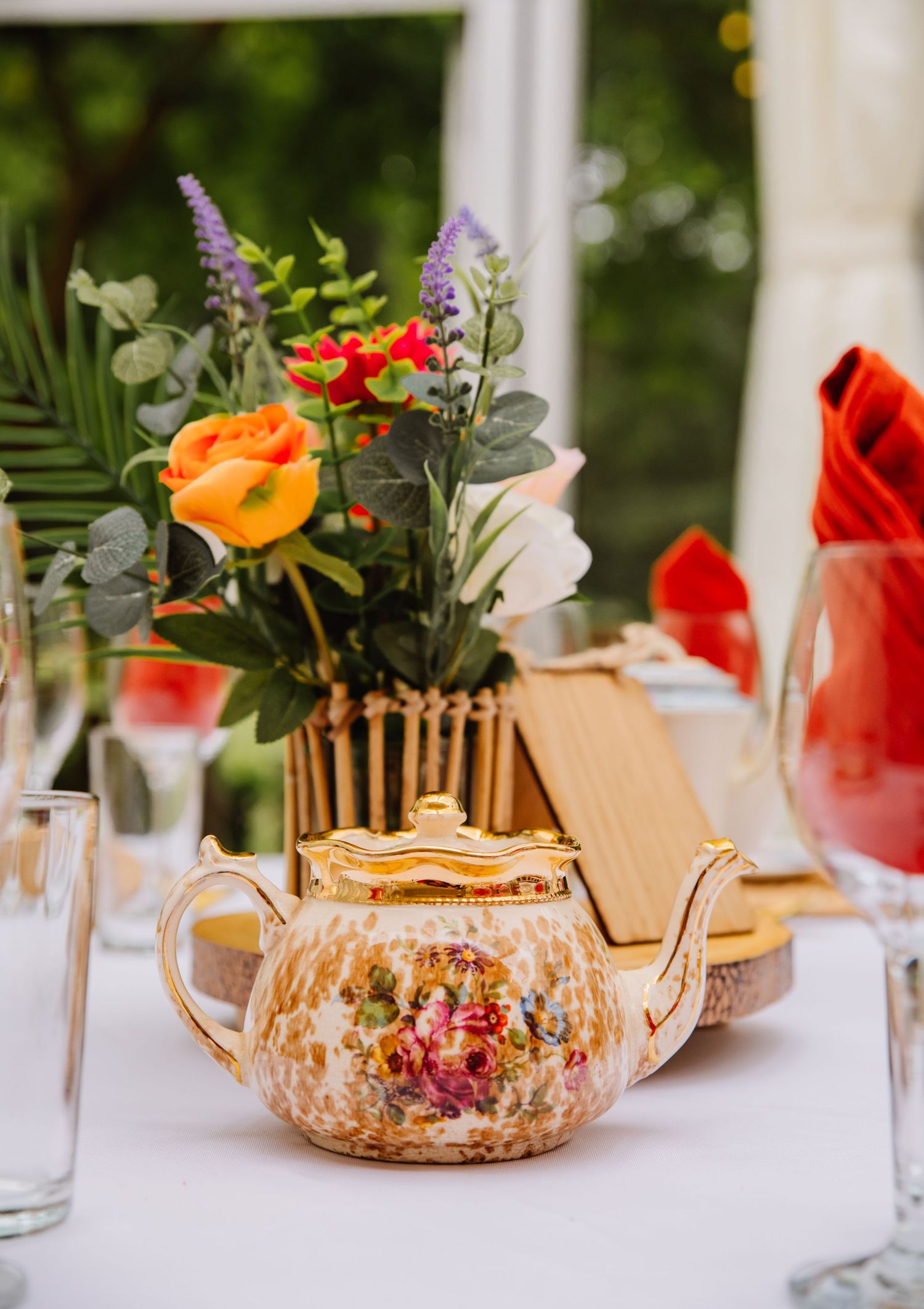 Tea pot and artificial florals at Abbotsbury Subtropical Garden, Dorset wedding venue. Dorset candid wedding photographer