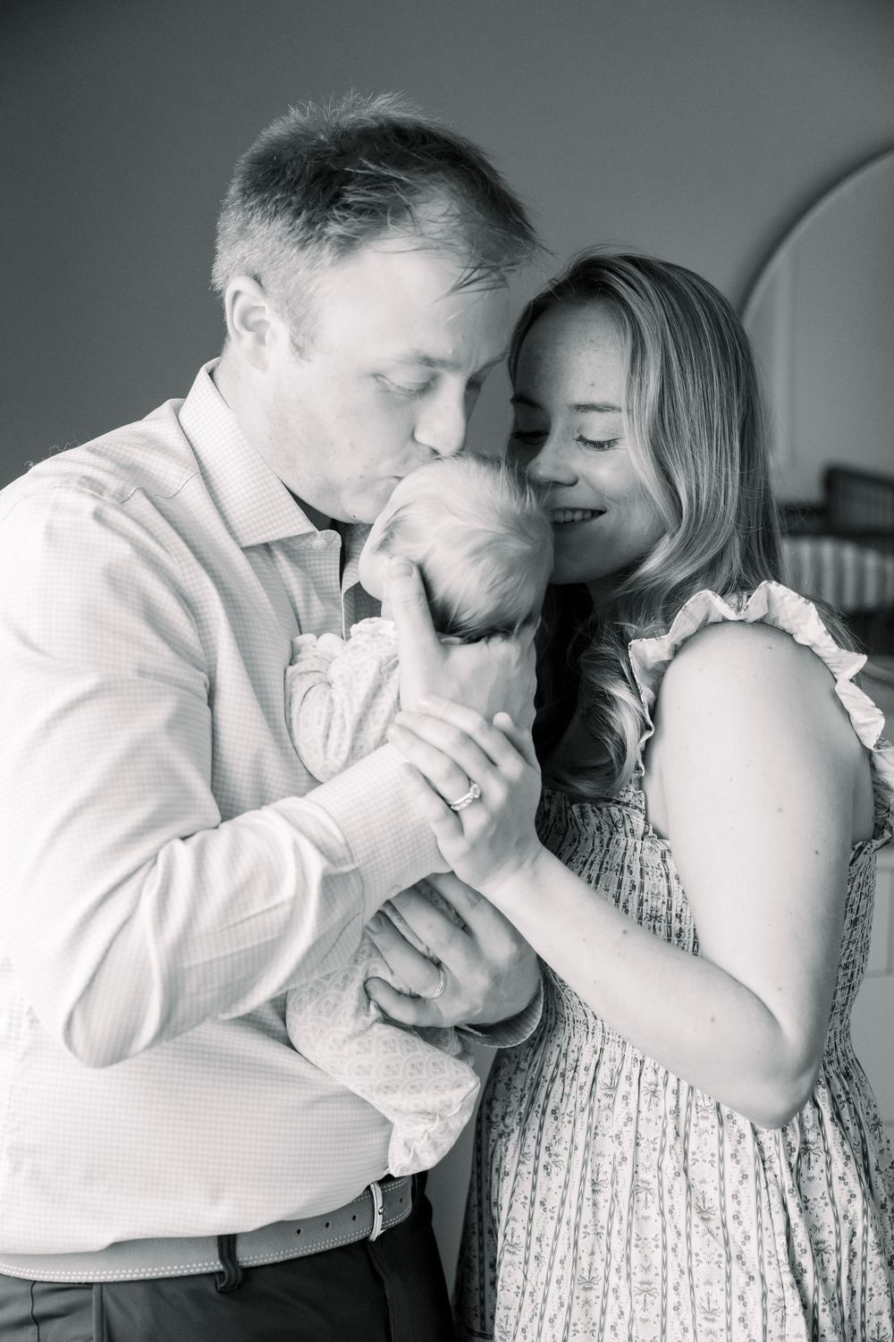 Intimate black and white portrait series showing tender moments between a couple in white clothing.