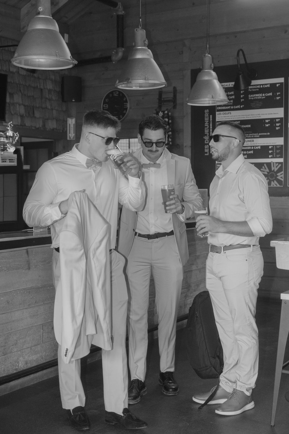 Vintage black and white photo showing a group of people in white uniforms gathered in an indoor space.