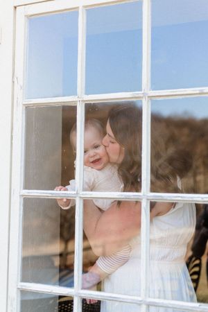 A playful sequence captured through window panes showing interaction behind glass.