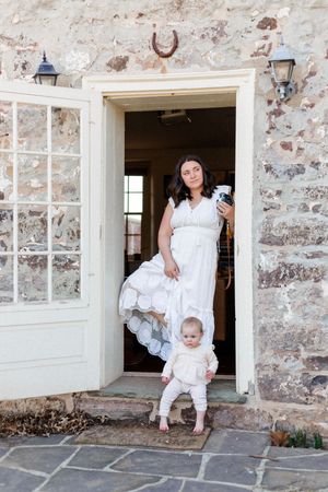 Four connected images showing joyful interactions near white-framed doorways of a rustic stone building.