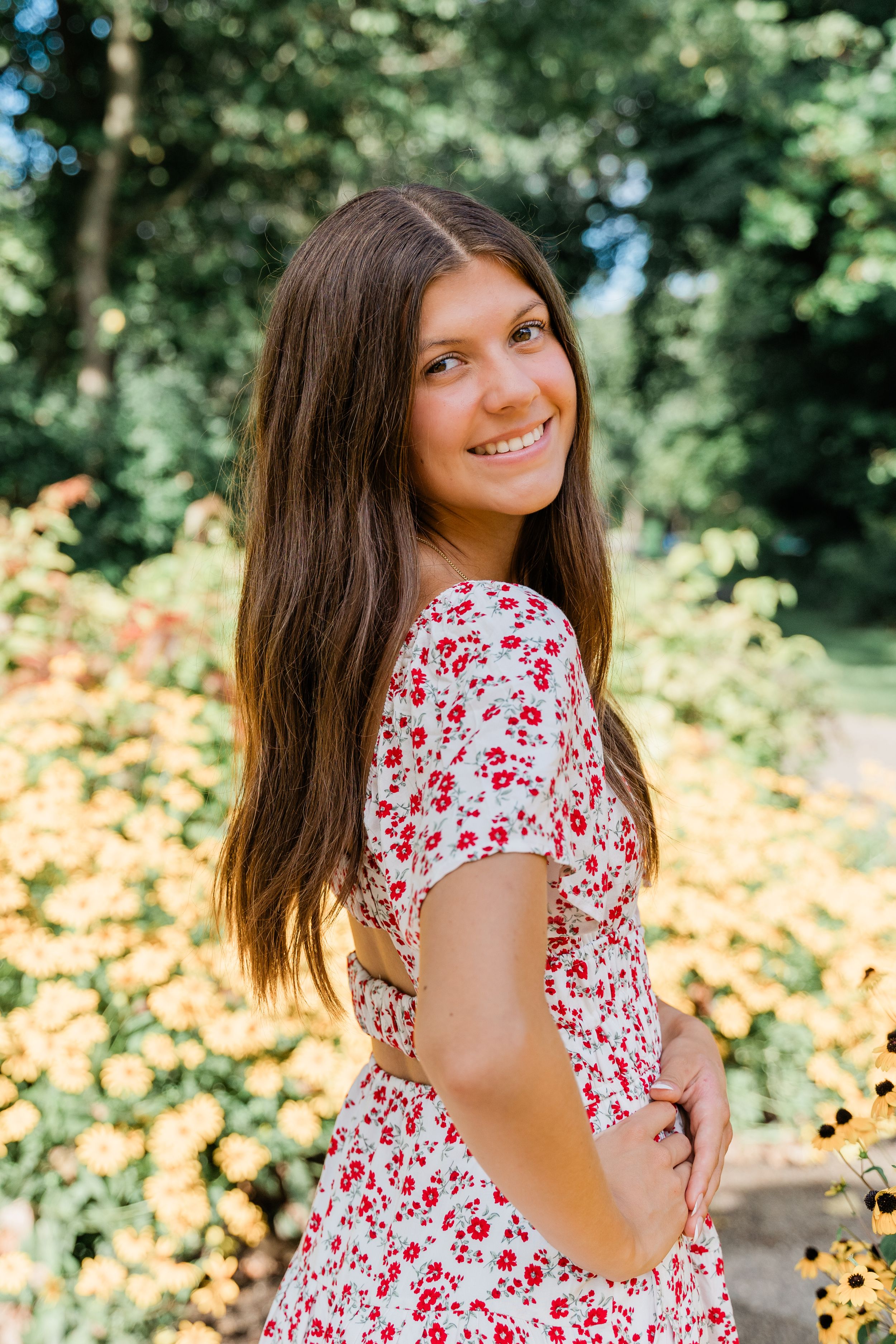 A series of outdoor portraits showing someone in a red and white floral dress against a blurred natural background.